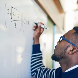 man doing math on whiteboard